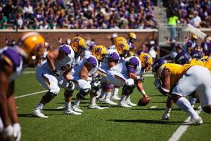 HSU football players setting up play at a game